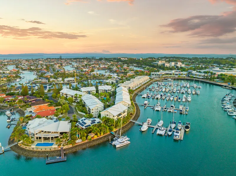 Raby Bay Harbour at sunset, with the marina, the canals and Cleveland behind